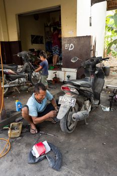 BALI, NUSA PENIDA ISLAND, INDONESIA - JULY 28.2015: Street motorbike service in Toyapakeh. Nusa Penida July 27. 2015 Indonesia