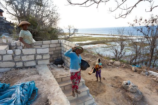 BALI, NUSA PENIDA ISLAND, INDONESIA - JULY 28.2015: Unidentified balinese indonesian woman with basket with seaweed. Nusa Penida July 27. 2015 Indonesia
