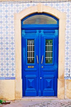 Wooden Door in the Wall Decorated with Portuguese Ceramic Tiles 
