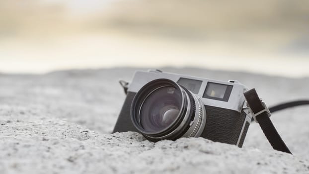 Vintage camera on stone with sunset sky background, Vintage style