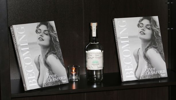UNITED KINGDOM, London: Cindy Crawford's new book Becoming and bottles of George Clooney's new tequila Casamigos Tequila are displayed at a joint launch at the Beaumont Hotel in central London on October 1, 2015. 