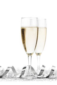 Two champagne glasses and silver ribbon on white background