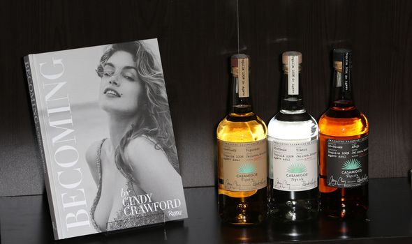 UNITED KINGDOM, London: Cindy Crawford's new book Becoming and bottles of George Clooney's new tequila Casamigos Tequila are displayed at a joint launch at the Beaumont Hotel in central London on October 1, 2015. 
