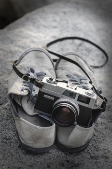 Vintage film camera on shoes with texture overlay background