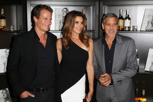 UNITED KINGDOM, London: Rande Gerber, Cindy Crawford and George Clooney attend the joint launch of Clooney's new tequila label, Casamigos Tequila, and Crawford's new book Becoming at the Beaumont Hotel in central London on October 1, 2015.  