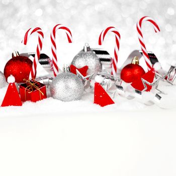 Christmas card with beautiful decorations and candies in snow