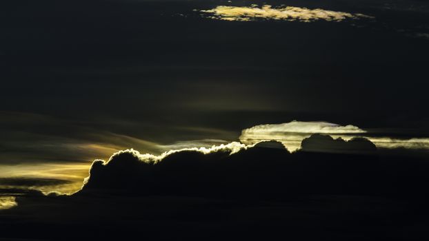 Silhouette of cloud with Iridescence on sunset sky background