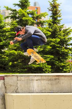 CALGARY, CANADA - JUN 21, 2015: Athletes have a friendly skateboard competition in Calgary. California law requires anyone under the age of 18 to wear a helmet while riding a skateboard.