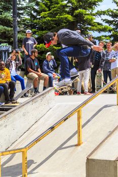 CALGARY, CANADA - JUN 21, 2015: Athletes have a friendly skateboard competition in Calgary. California law requires anyone under the age of 18 to wear a helmet while riding a skateboard.