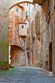 Narrow Alley with Old Buildings in Italian City of Todi