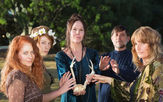 Adults in pagan ceremony feeling mystical power of antlers