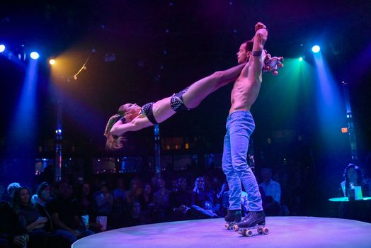 CANADA, Toronto:  Mariia Beseimbetova and Denis Petaov perform a dizzying roller skating act at Spiegelworld's Empire in Toronto on October 1, 2015. 