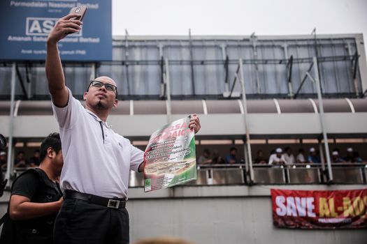 MALAYSIA, Kuala Lumpur: A man takes a selfie at a rally in front of US Embassy in Kuala Lumpur, Malaysia on October 2, 2015. Protesters urge Americans to act against its ally Israel following clashes at Al-Aqsa mosque, between Israeli security forces and Palestinians Muslims.These pictures show hundreds of people holding signs, banners and waving flags as they parade in the Malaysian capital.