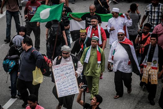 MALAYSIA, Kuala Lumpur: Protesters march and hold flags during a demonstration in front of US Embassy in Kuala Lumpur, Malaysia on October 2, 2015. Protesters urge Americans to act against its ally Israel following clashes at Al-Aqsa mosque, between Israeli security forces and Palestinians Muslims.These pictures show hundreds of people holding signs, banners and waving flags as they parade in the Malaysian capital.
