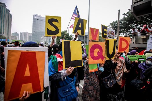MALAYSIA, Kuala Lumpur: Demonstrators hold up signs to save the mosque during a rally in front of US Embassy in Kuala Lumpur, Malaysia on October 2, 2015. Protesters urge Americans to act against its ally Israel following clashes at Al-Aqsa mosque, between Israeli security forces and Palestinians Muslims.These pictures show hundreds of people holding signs, banners and waving flags as they parade in the Malaysian capital.
