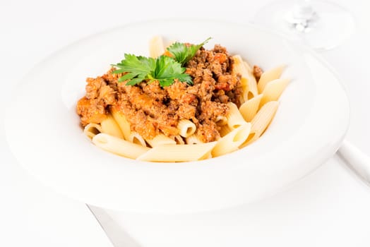 Pasta. Penne Pasta with Bolognese Sauce, Parmesan Cheese and Basil, Fork. Italian Cuisine. Mediterranean food