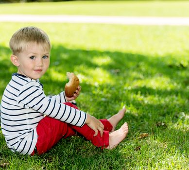 Little preschool boy portrait, outdoors.