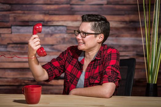 Single frustrated young women on a stressful phone call