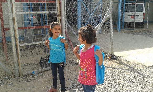 IRAQ, Kurdistan: Two young girls prepare for school in Kawergosk camp in Kurdistan on October 1, 2015. Syrian refugee students attend school on the second day of new year study.Thousands of refugees have been forced to flee Syria as a result of the civil war which has been raging for more than four years.  