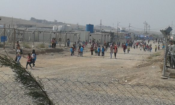IRAQ, Kurdistan: A wide shot of children walking to school in the Kawergosk refugee camp in Kurdistan on October 1, 2015. Syrian refugee students attend school on the second day of new year study.Thousands of refugees have been forced to flee Syria as a result of the civil war which has been raging for more than four years.  
