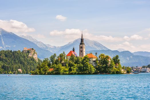 Little Island with Catholic Church and Bled Castle on Bled Lake, Slovenia with Mountains in Background