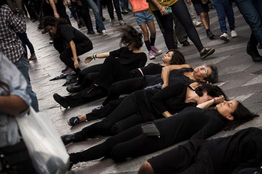 SPAIN, Madrid: Women dressed in all black feign their own death in downtown Madrid as part of a performance protest, on October 2, 2015, denouncing gender-based violence. 
