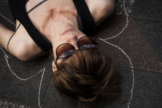 SPAIN, Madrid: A woman dressed in all black feigns her own death in downtown Madrid as part of a performance protest, on October 2, 2015, denouncing gender-based violence. 