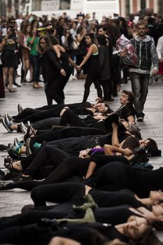 SPAIN, Madrid: Women dressed in all black feign their own death in downtown Madrid as part of a performance protest, on October 2, 2015, denouncing gender-based violence. 