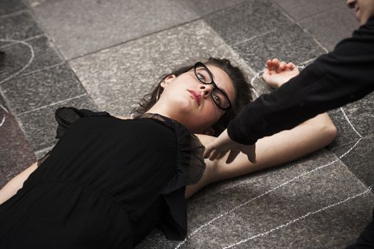 SPAIN, Madrid: A woman dressed in all black feigns her own death in downtown Madrid as part of a performance protest, on October 2, 2015, denouncing gender-based violence. 