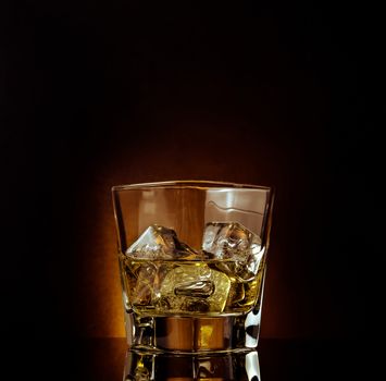 glass of whiskey on black table with reflection, warm atmosphere, time of relax with whisky