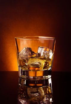 glass of whiskey on black table with reflection, warm tint atmosphere, time of relax with whisky