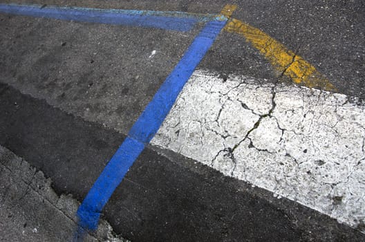 Asphalt road background with yellow, white and blue lines