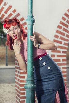 View of pinup young woman in vintage style clothing surprised.