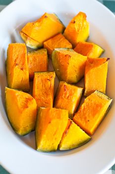 Plate pumpkin roasted in the oven and seasoned with olive oil and salt