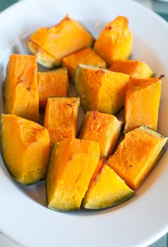 Plate pumpkin roasted in the oven and seasoned with olive oil and salt