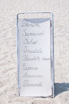 Menu of a restaurant on the beach where there is' wrote: "Panini", "salad", "bruschetta" and "arancini".