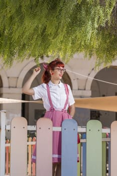 View of pinup young woman in vintage style clothing on the streets of Faro city.