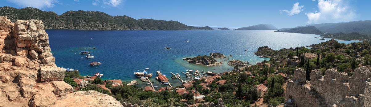 DEMRE, ANTALYA - JULY 18, 2015 : Seascape of Kekova Ancient Lycian City in Antalya, with sailing boats and yachts around, on bright blue sky background.