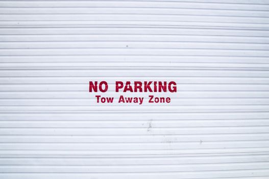 No Parking sign on corrugated metal doorway