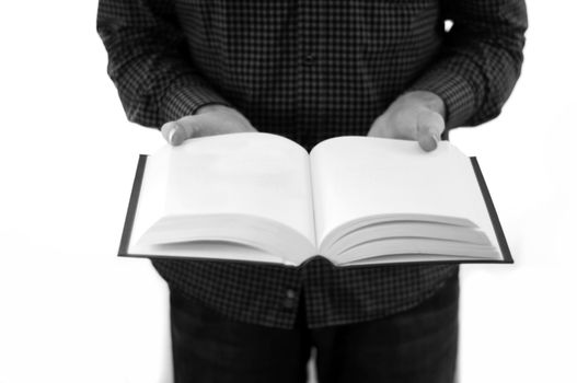 Man holding large open book with blank pages, isolated on a white background