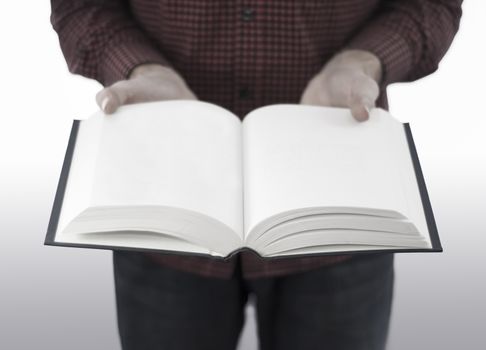 Man holding large open book with blank pages, isolated on a white background