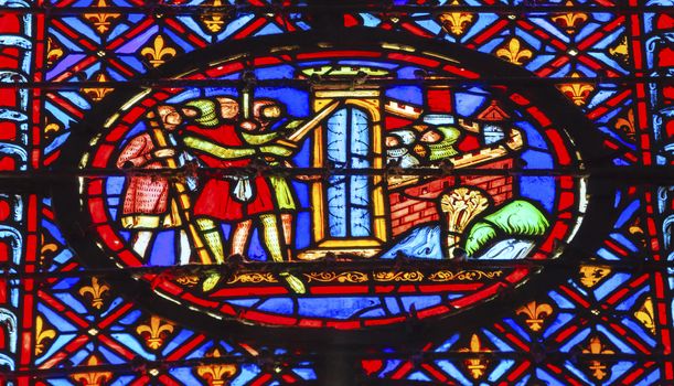 Knights Castle Siege Stained Glass Saint Chapelle Paris France.  Saint King Louis 9th created Sainte Chapelle in 1248 to house Christian relics, including Christ's Crown of Thorns.  Stained Glass created in the 13th Century and shows various biblical stories along wtih stories from 1200s.