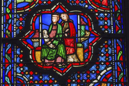 Jesus Mary Joseph Stained Glass Saint Chapelle Paris France.  Saint King Louis 9th created Sainte Chapelle in 1248 to house Christian relics, including Christ's Crown of Thorns.  Stained Glass created in the 13th Century and shows various biblical stories along wtih stories from 1200s.
