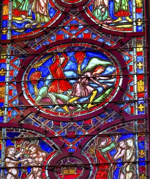 Cain Able Adam Eve Stained Glass Saint Chapelle Paris France.  Saint King Louis 9th created Sainte Chapelle in 1248 to house Christian relics, including Christ's Crown of Thorns.  Stained Glass created in the 13th Century and shows various biblical stories along wtih stories from 1200s.