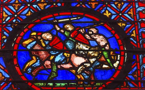 Knights Chasing Medieval Life Stained Glass Saint Chapelle Paris France.  Saint King Louis 9th created Sainte Chapelle in 1248 to house Christian relics, including Christ's Crown of Thorns.  Stained Glass created in the 13th Century and shows various biblical stories along with stories from 1200s.