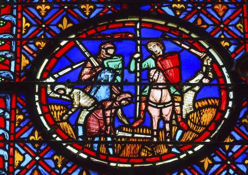 Knights Peasants Field Medieval Life Stained Glass Saint Chapelle Paris France.  Saint King Louis 9th created Sainte Chapelle in 1248 to house Christian relics, including Christ's Crown of Thorns.  Stained Glass created in the 13th Century and shows various biblical stories along with stories from 1200s.