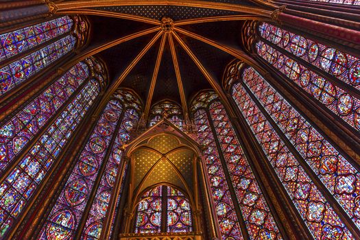 Stained Glass Cathedral Ceiling Saint Chapelle Paris France.  Saint King Louis 9th created Sainte Chapelle in 1248 to house Christian relics, including Christ's Crown of Thorns.  Stained Glass created in the 13th Century and shows various biblical stories along with stories from 1200s.