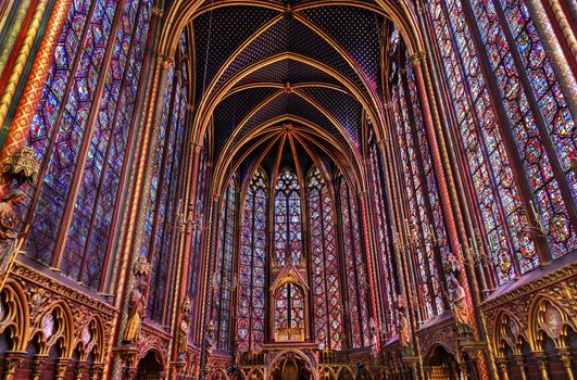 Stained Glass Cathedral Saint Chapelle Paris France.  Saint King Louis 9th created Sainte Chapelle in 1248 to house Christian relics, including Christ's Crown of Thorns.  Stained Glass created in the 13th Century and shows various biblical stories along with stories from 1200s.