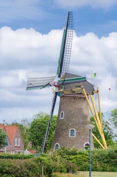 Historic old windmill in the province of Zeeland, Netherlands against blue sky.
