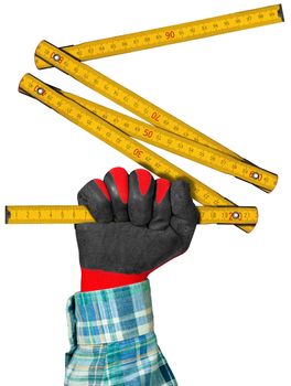 Hand with red and black work glove holding a yellow and old wooden folding ruler. Isolated on white background. 